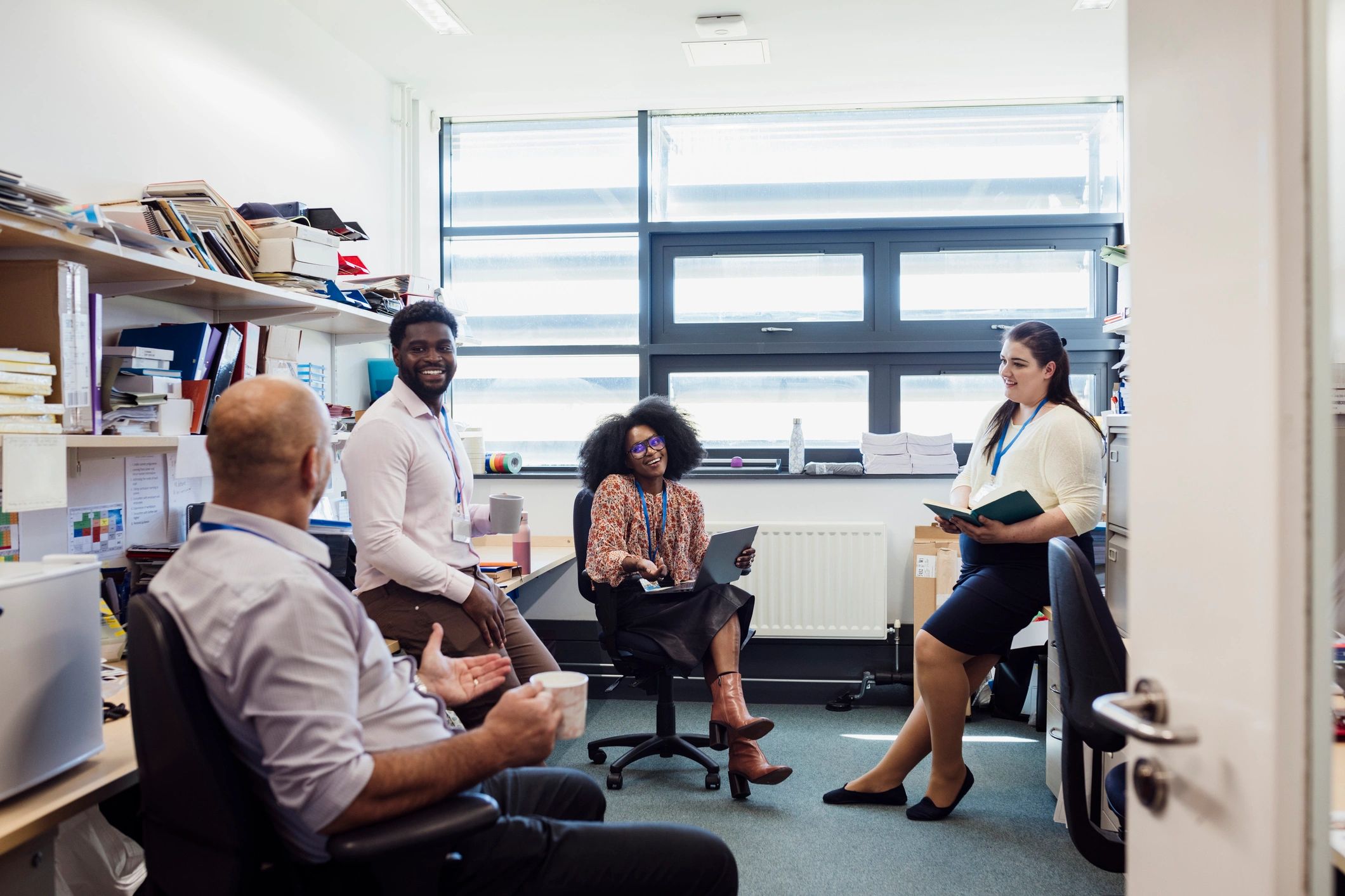 Education team in an office discussing work